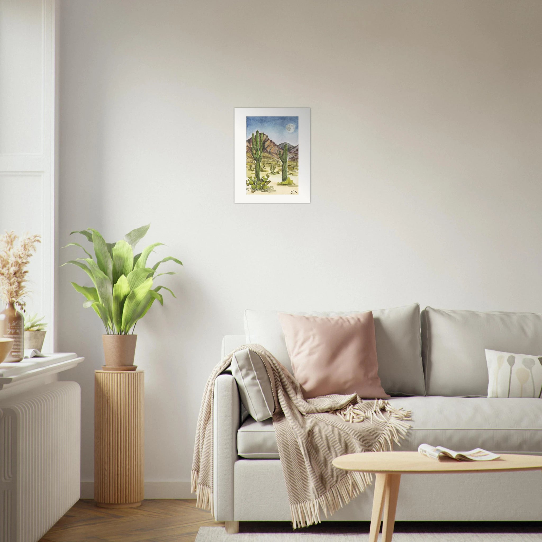 Fine art print by Houston based artist Jenny Wagner, Desert Moon. This watercolor print depicts a desert scene with saguaro cacti and a full moon in the background. Print shown on a neutral living room wall