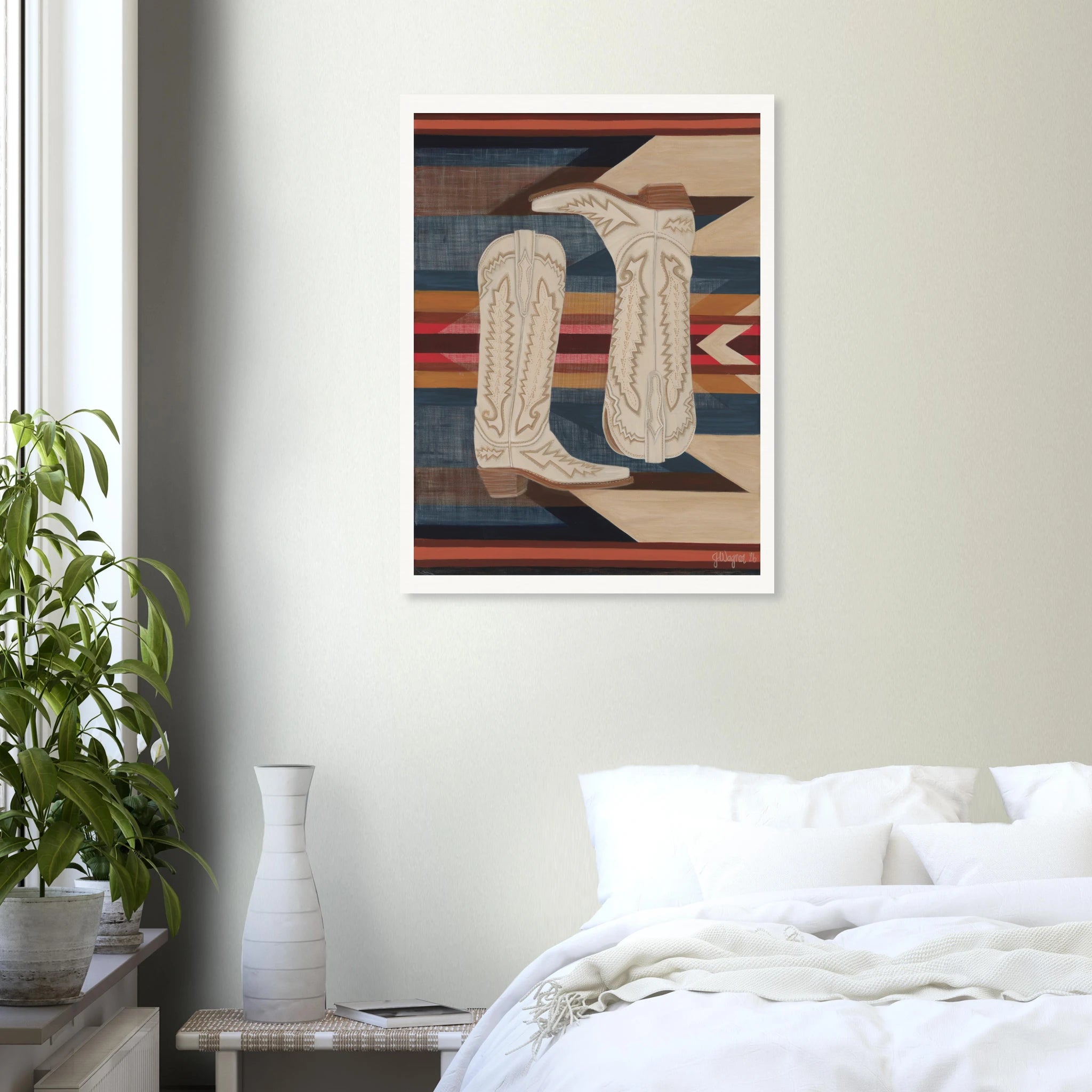 Fine art western print, Paired, by Jenn Wagner shown in large format in a neutral bedroom. This print features cream western boots on a southwest patterned background