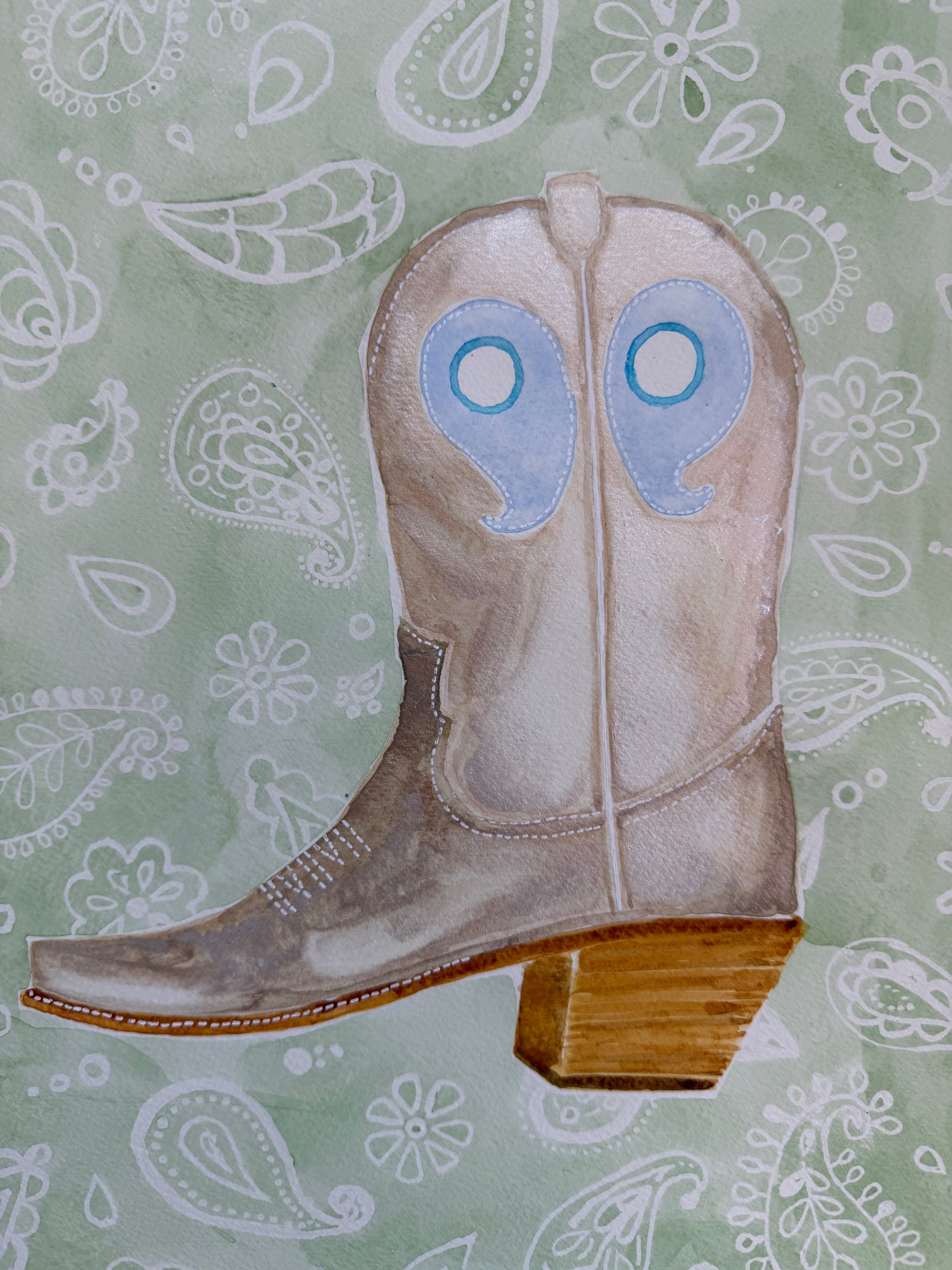 close up of metallic boot watercolor on a paisley pattern