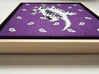 Side view of Texas artist Jenny Wagners original mixed media piece, Purple Reign featuring a white horned frog with hand beading on a purple bandana