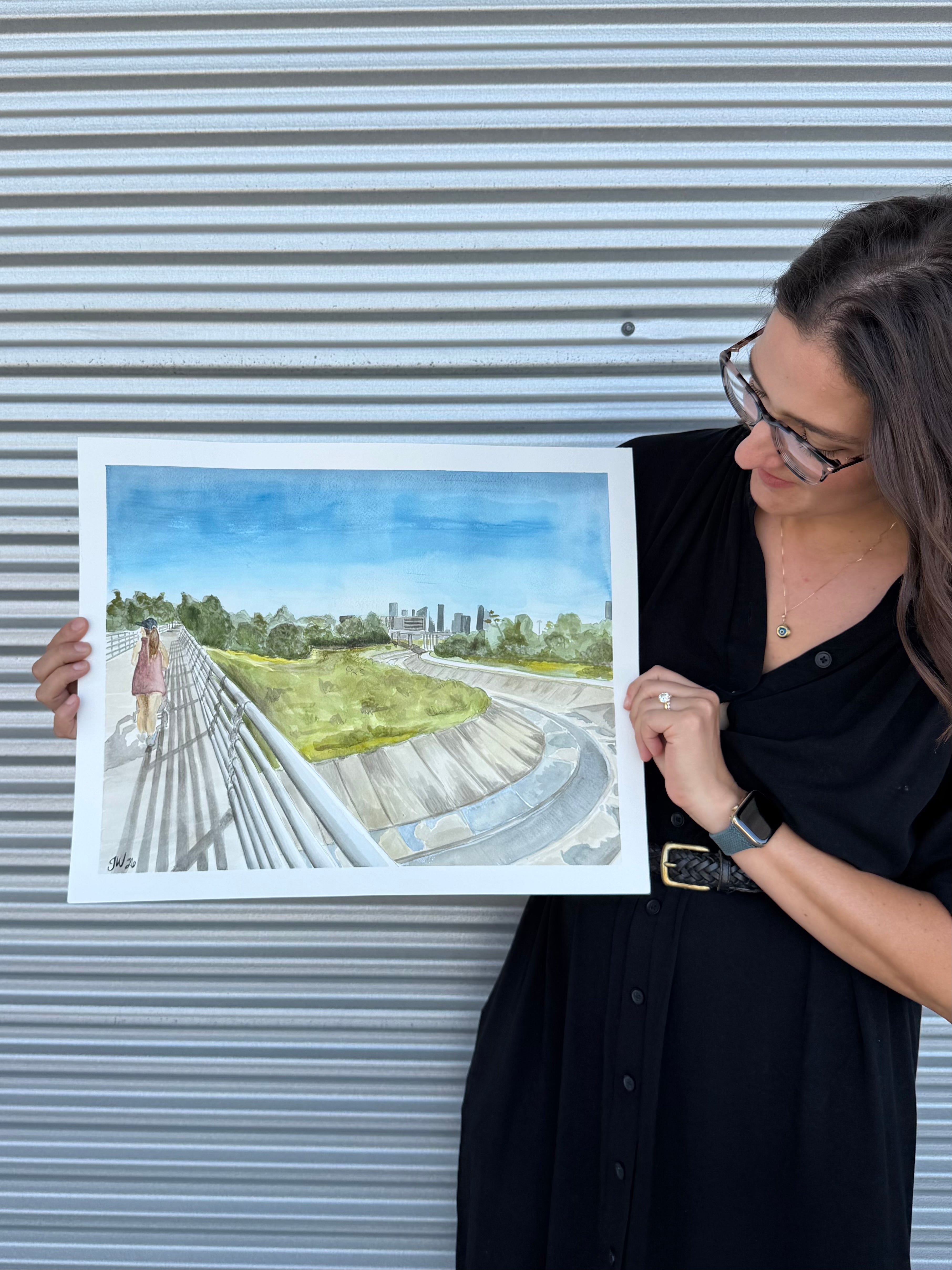 Artist Jenny Wagner displaying the original watercolor painting "The Bayou Walk"