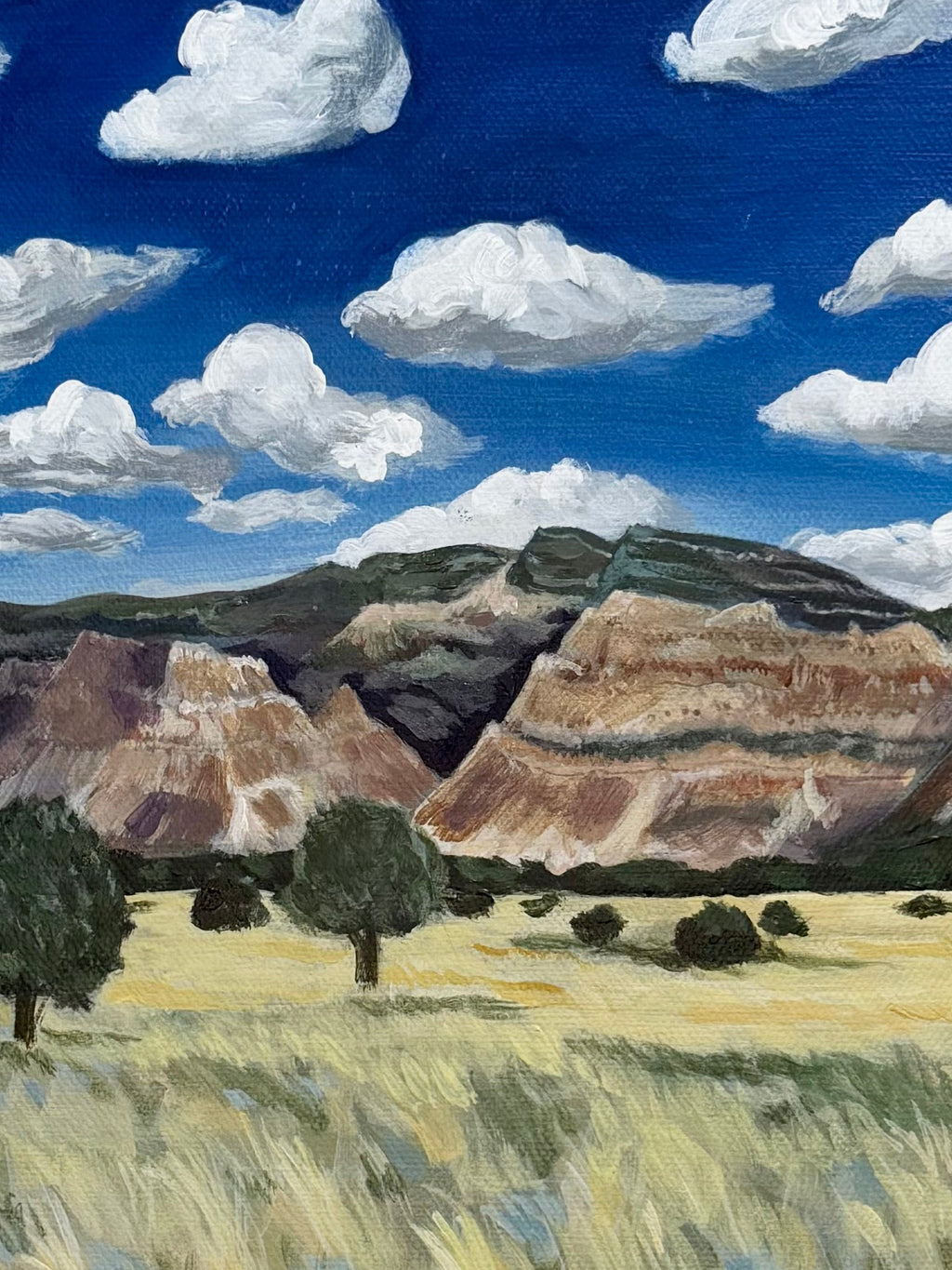 Close-up of textured brushstrokes showing the mountains and clouds in the original acrylic painting "Colorado to Utah"