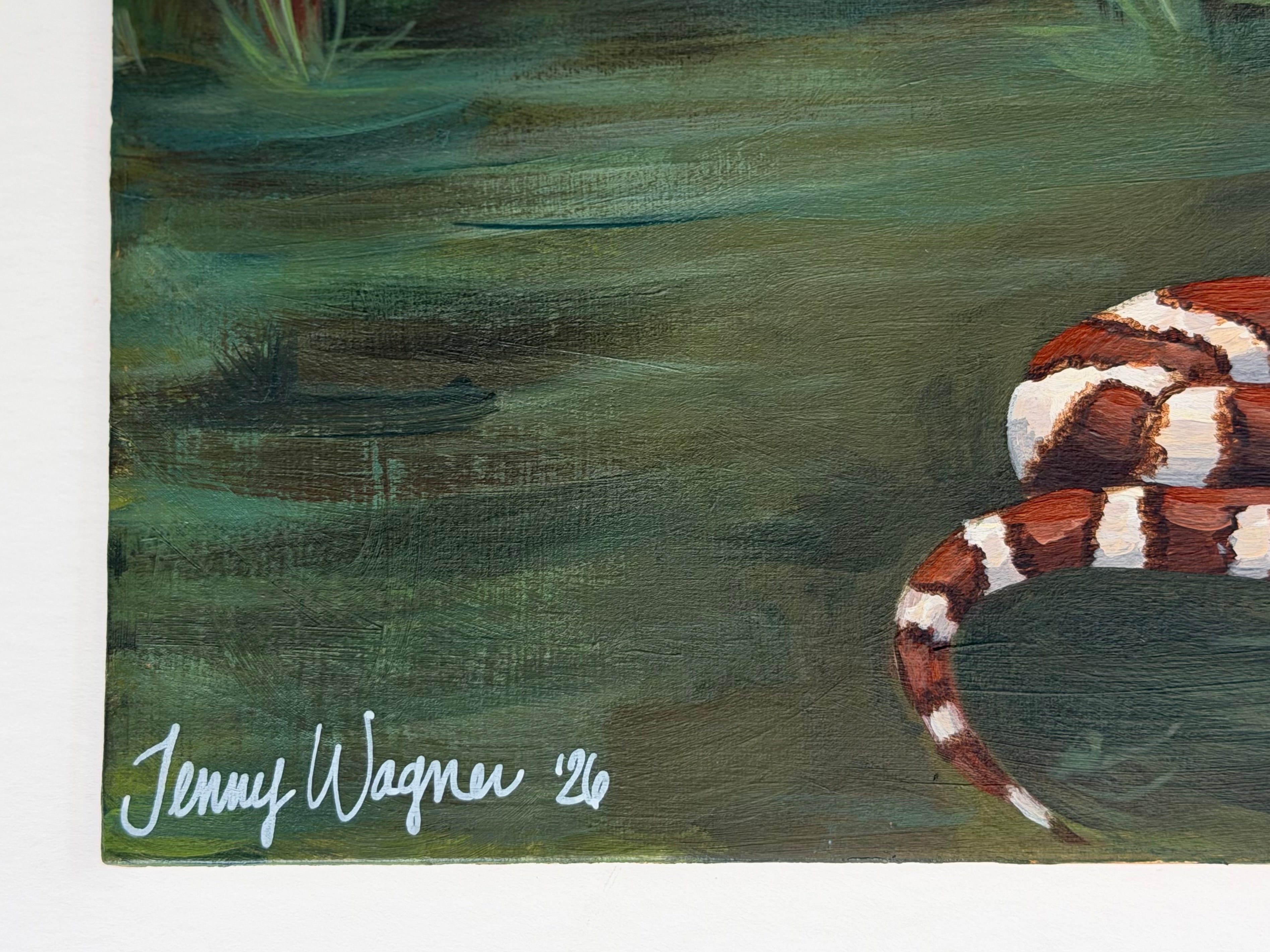 Close up on the signature of Jenny Wagner on her original 12x12 acrylic painting of a Texas landscape, featuring a copperhead snake